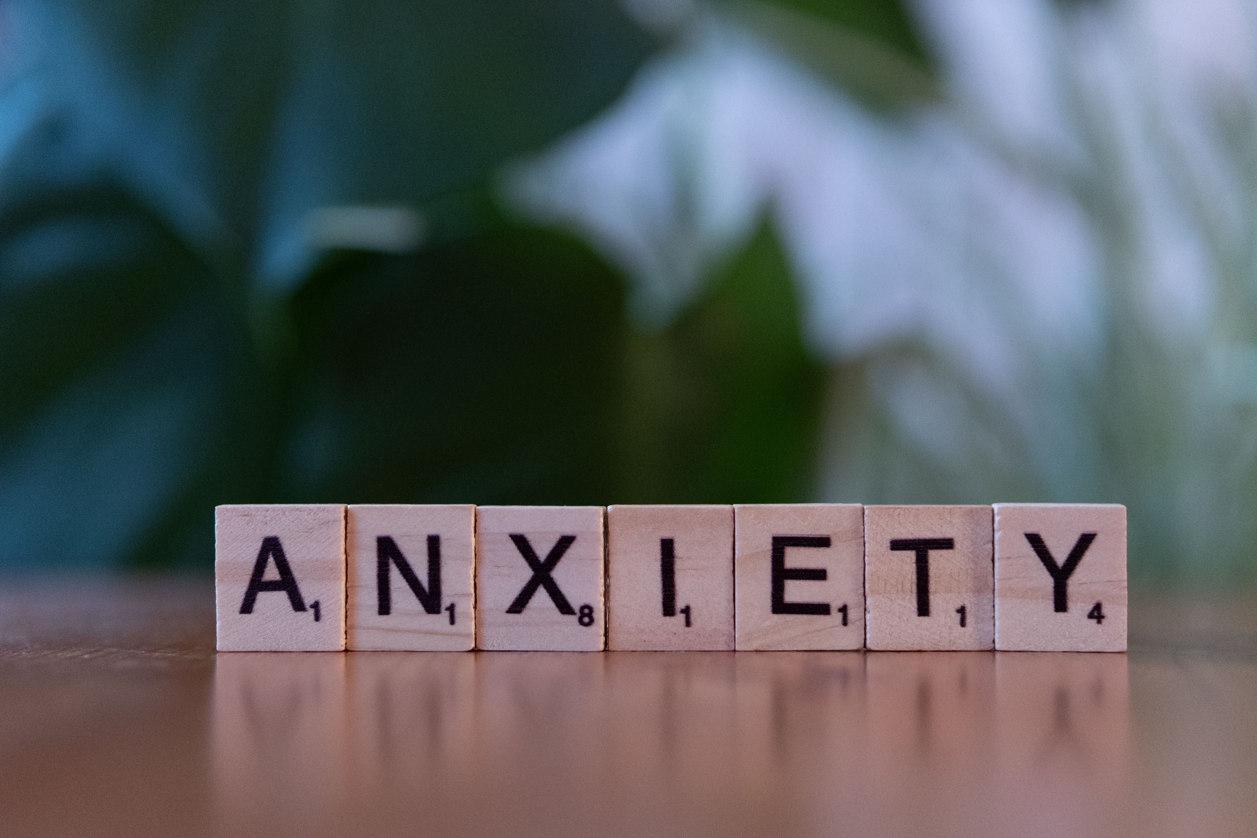 A person pausing thoughtfully by a window — anxiety care.